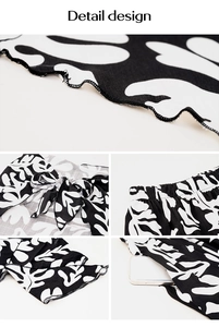 Detail view of bohemian print shorts featuring elastic waist, bow tie, and wavy hem design