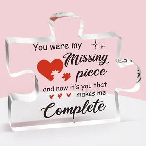 Detailed view of puzzle-shaped clear acrylic plaque with romantic text and a red heart
