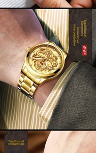 Detailed view of the golden watch with embossed dragon dial and crystal markers