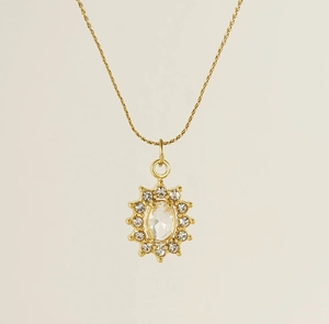 Detailed close-up of a gold sunflower pendant with oval zircon crystal and halo diamonds