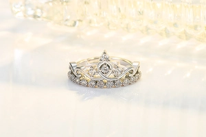 Macro shot of silver crown ring with sparkling cubic zirconia stones and intricate metalwork