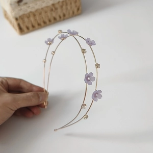 Detail of double-layer purple flower headband with frosted petals, pearls, and crystals