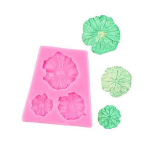 Pink silicone mold featuring lotus leaf designs with green finished handmade resin pieces