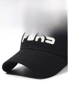 Detailed close-up of the curved brim and white 3D embroidery on this black cotton baseball cap