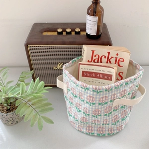 Quilted blue checkered storage basket with pink tulips and cream handles for home decor