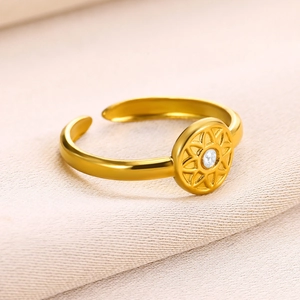 Detail of 18k gold plated stainless steel ring with sunburst pattern and zircon inlay