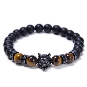 Macro view of wolf head bead bracelet with tiger eye stones and matte black beads