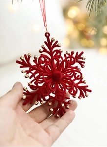 Macro detail of red flocked snowflake ornament with gold bead edges for Christmas tree