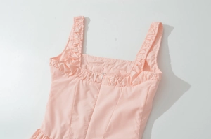 Detailed flat lay of pink vintage square neck dress with ruffled straps and back zipper