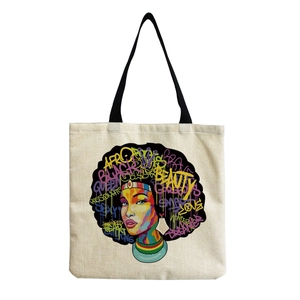 Detail of artistic canvas tote bag with colorful portrait print and black handles