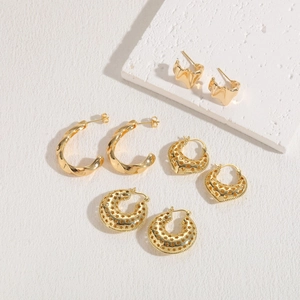 Macro display of 14K gold plated geometric hoop earrings with hollow stars and hearts