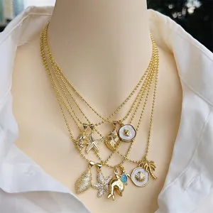 18K gold plated ocean series necklace with dolphin and shell pendants on mannequin