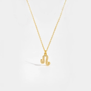 Macro shot of gold-plated S925 silver Leo constellation pendant with white zircon stones