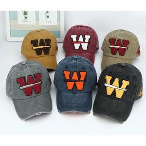 Multiple vintage washed baseball caps with embroidered W logo and worn-out brim details