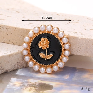 Macro detail of 2.5cm vintage zinc alloy rose heart charm with faux pearls and gold trim