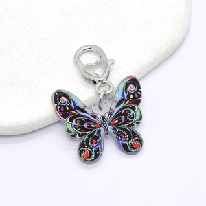 Macro detail of acrylic butterfly keychain with colorful patterns and heart clasp