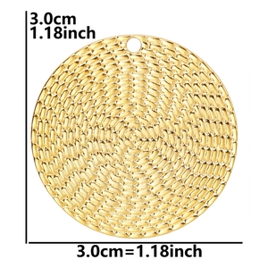 Macro detail of 3cm golden 18k plated circular pendant with woven metal texture