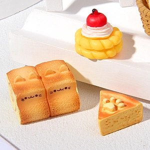 Set of 3 miniature resin cat-themed bread and dessert toys displayed on a white stand