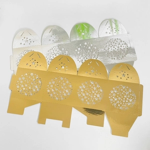 Flat lay of laser-cut gold and silver star hollow candy boxes in metallic cardstock