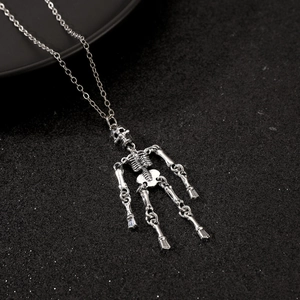 Detailed close-up of gothic skull pendant on a silver chain with dark textured backdrop