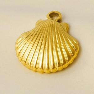 Macro shot of 304 stainless steel golden shell pendant showing detailed ocean textures