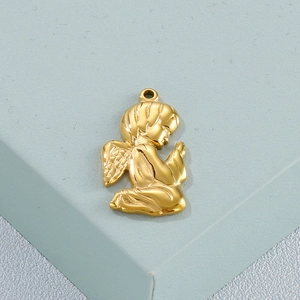 Close-up of a golden titanium steel angel pendant in a praying pose with wing details