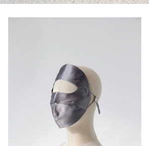 Detail of grey mulberry silk sun mask with smooth texture and side eye-opening design