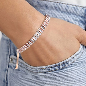 Adjustable rose gold bracelet featuring rectangular cut cubic zirconia worn on wrist