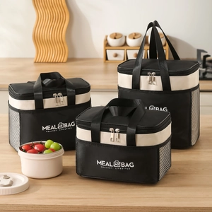 Three-piece insulated lunch bag set in black and white with reinforced handles and mesh pocket