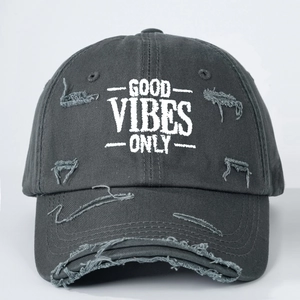 Detail of Good Vibes Only embroidery and distressed rips on charcoal baseball cap