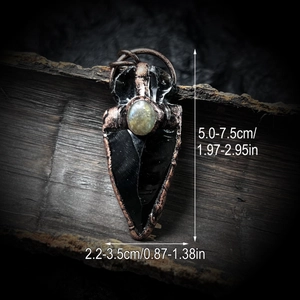 Handcrafted obsidian arrow pendant wrapped in antique bronze with moonstone inlay