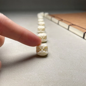 Macro shot of a hand-carved white Bodhi nut lion head bead for jewelry making