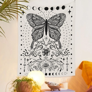 Detail of bohemian black and white tapestry with butterfly, moon phases and stars pattern