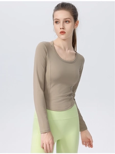 Detail of slim fit long sleeve yoga top with curved hem in mocha earthy tone