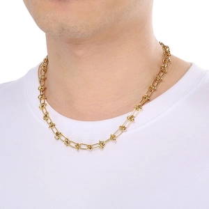 Close-up of 18k gold plated titanium steel knotted chain necklace worn by a model
