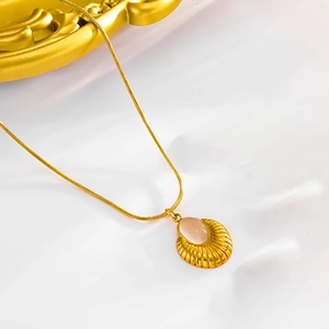 Minimalist gold necklace with pink oval gemstone and sunburst shell textured pendant