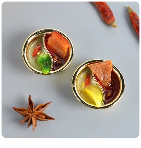 Top view of miniature hot pot charms with realistic resin ingredients and spices