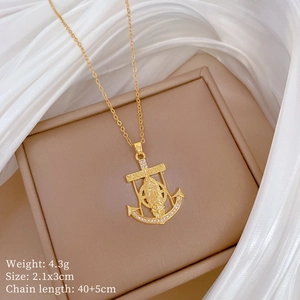 Detail of gold anchor portrait pendant with crystal pavé and product dimensions text
