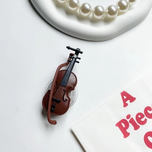 Close-up of violin phone stand with 3D resin details and transparent adhesive base