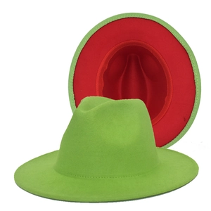 Detail of wool fedora hat showing contrast grass green top and red underside wide brim