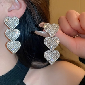 Luxurious tiered rhinestone heart drop earrings featuring sparkling silver tassel design