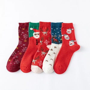 Five pairs of cozy wool Christmas socks with festive reindeer and Santa patterns