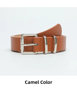 Close-up of camel leather belt with yellow stitching and polished silver buckle