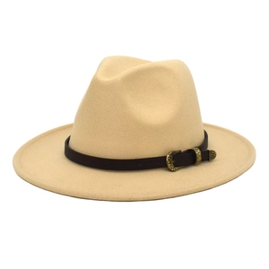 Detail of wool fedora hat featuring tan felt material and brown leather belt buckle