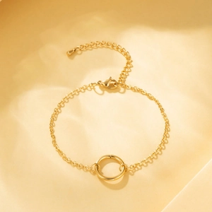 Minimalist 18K gold stainless steel geometric round link bracelet for women on textured surface