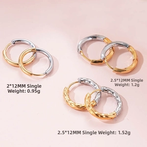 Macro view of 12mm two-tone titanium steel hoop earrings with three distinct textures