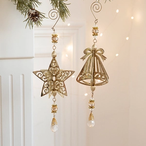 Golden Christmas tree metal ornaments with star and bell charms on pine branches