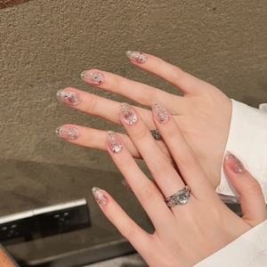 Pink velvet cat-eye press-on nails with silver heart charms and pearls in long oval shape