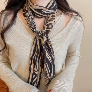 Detail of elegant animal print fabric scarf necklace with leopard and zebra patterns