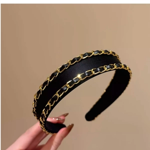 Elegant black fabric headband featuring dual gold chain and leather woven detail for women